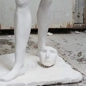 Image of the legs, feet and face of Objectification I - a plaster sculpture by Adesina